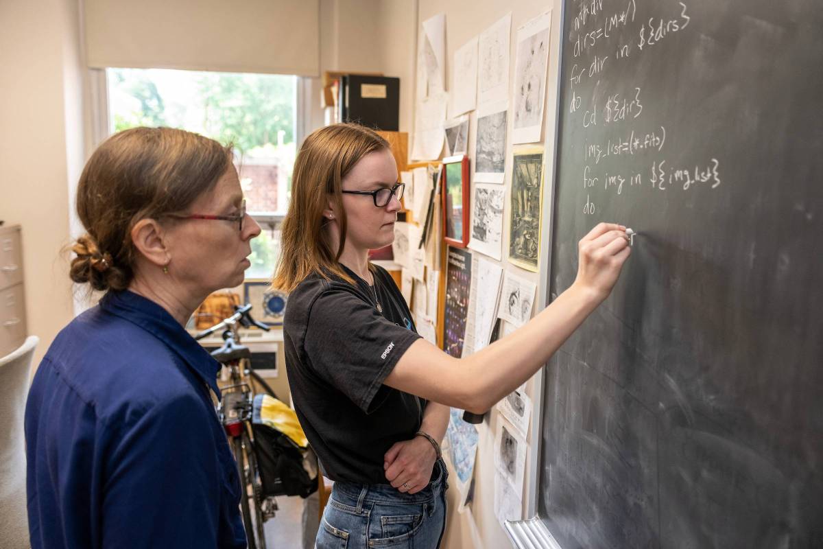 Student and professor engage in physics research